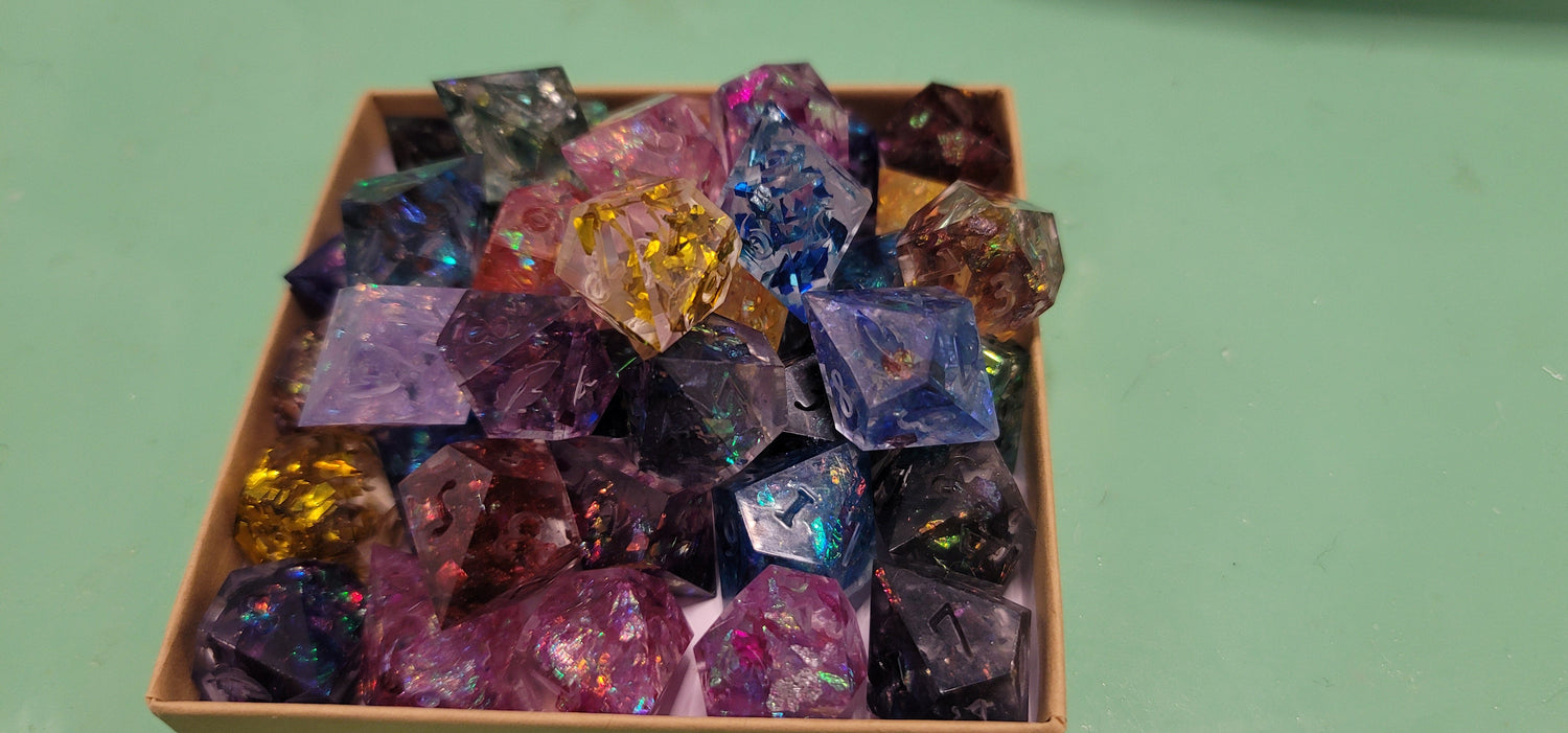 A pile of unfinished dice in various colors.